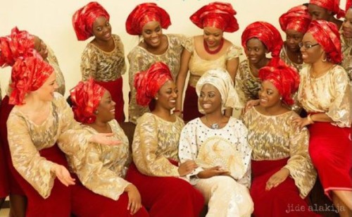 photo: bride's friends wearing red and gold aso-ebi colours