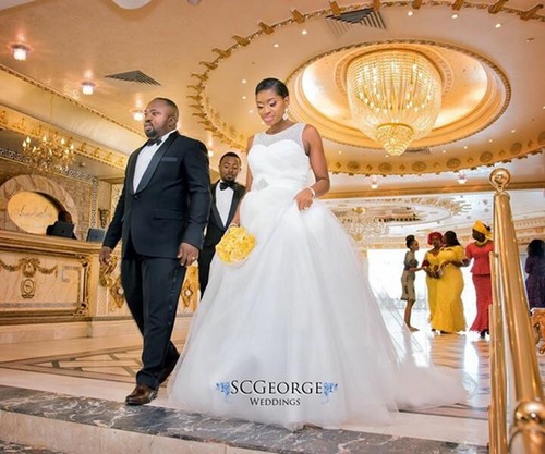 couple at yellow themed Nigerian white wedding
