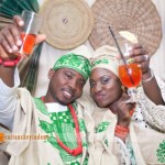 yoruba couple in green aso-oke toasting to a drink