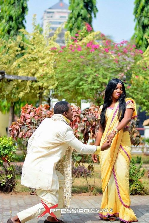 couple poses in their indian themed engaagement photo session