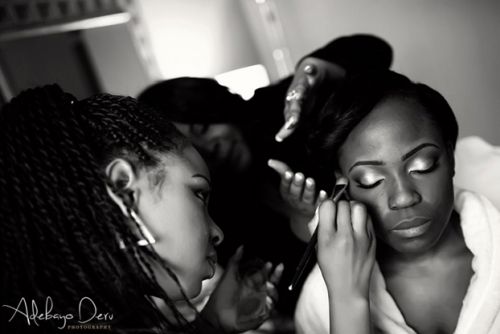 bride getting makeup for her wedding