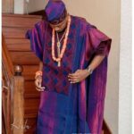 groom in burgundy and blue embroidered agbada with cap