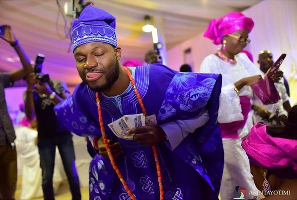 picture: yoruba groom in blue aso-oke dancing at traditional engagement