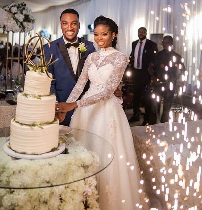 couple cutting wedding cake nigeria akahandclaire