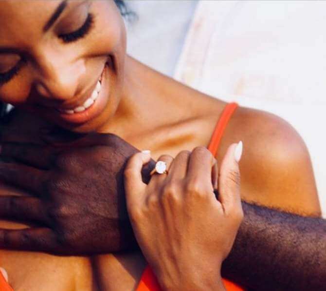 photo showing off engagement rings and black mans hand